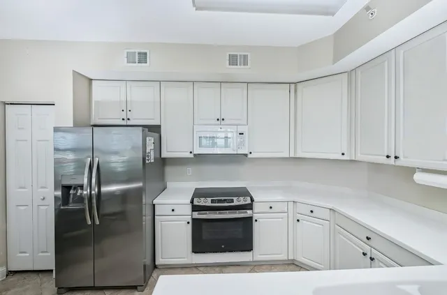 a view of a dining room with furniture and a chandelier