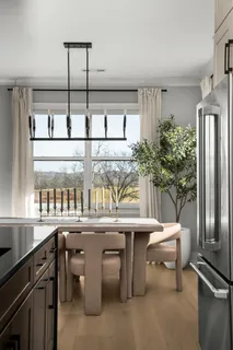 a kitchen with a sink and chairs