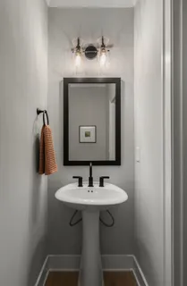 a large bedroom with a bed and a chandelier