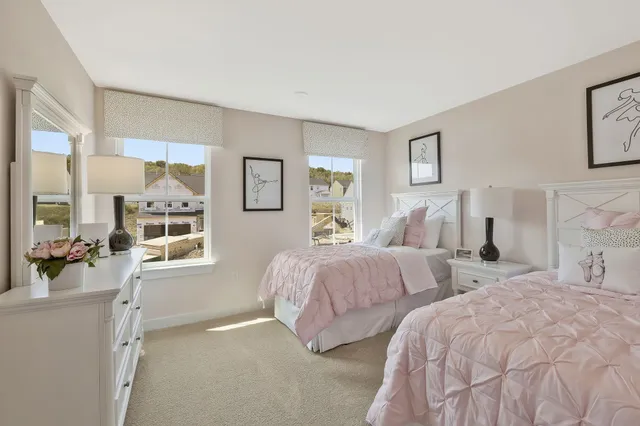 a bedroom with two beds and painting on the wall