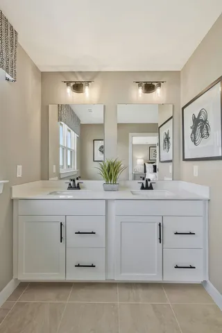 a bathroom with a sink vanity and mirror