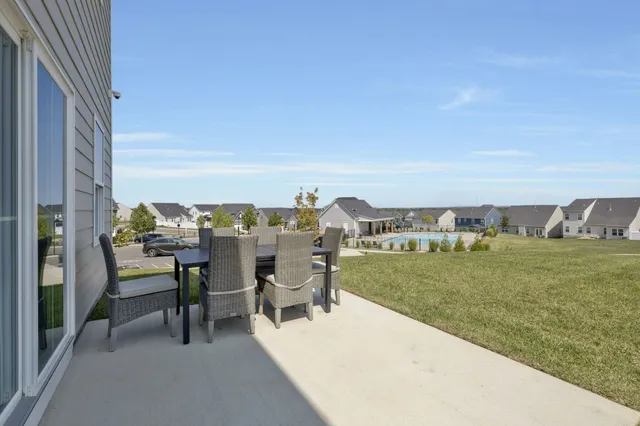 a view of a terrace with a table and chairs