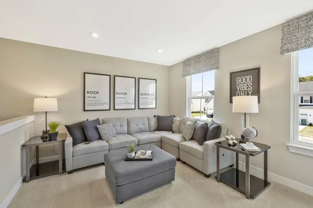 a living room with furniture and a large window