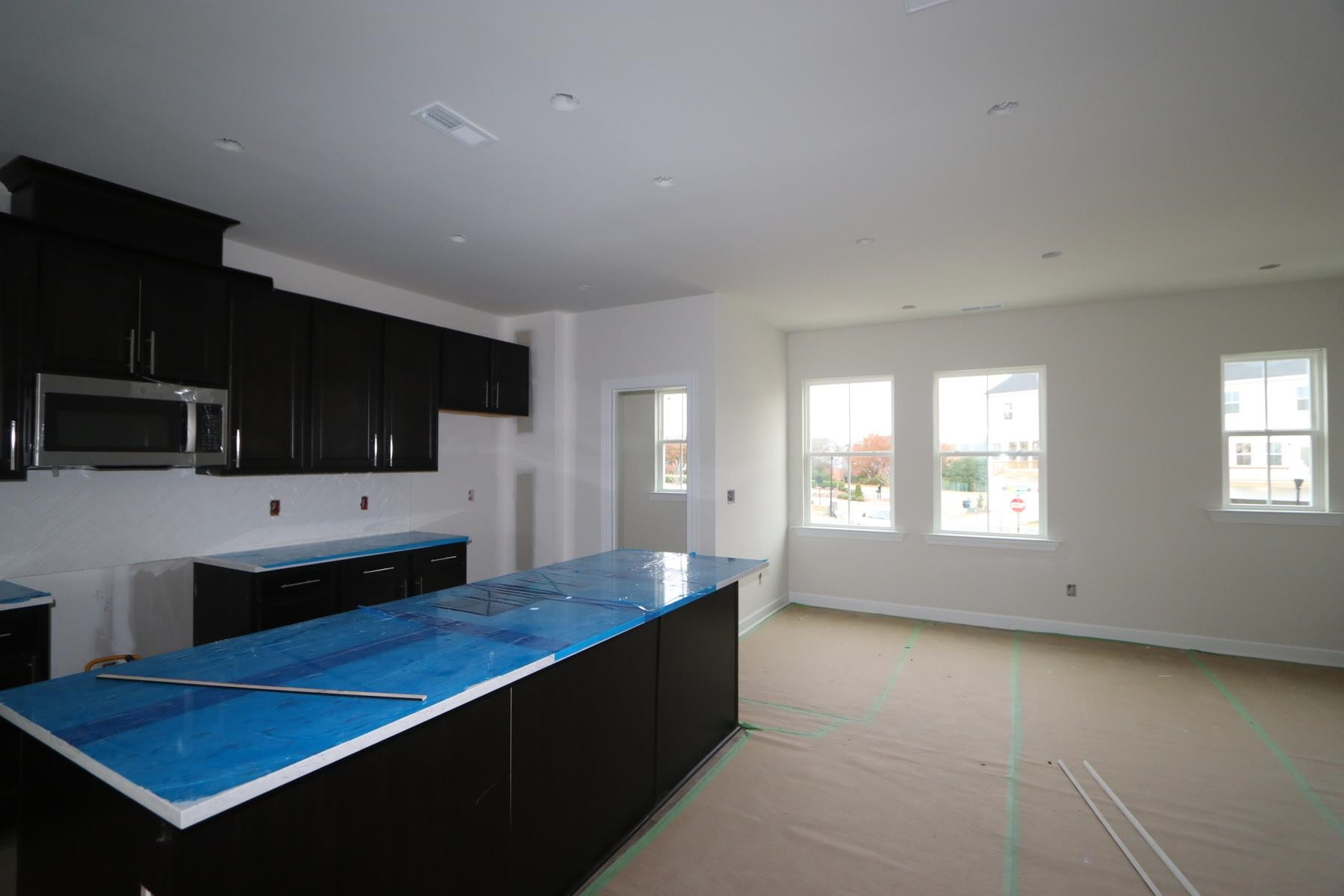 816 Lilyquist Way Wake Forest, NC 27587 - Photo 3 of 6 a kitchen with kitchen island a sink dishwasher stove and oven with wooden floor