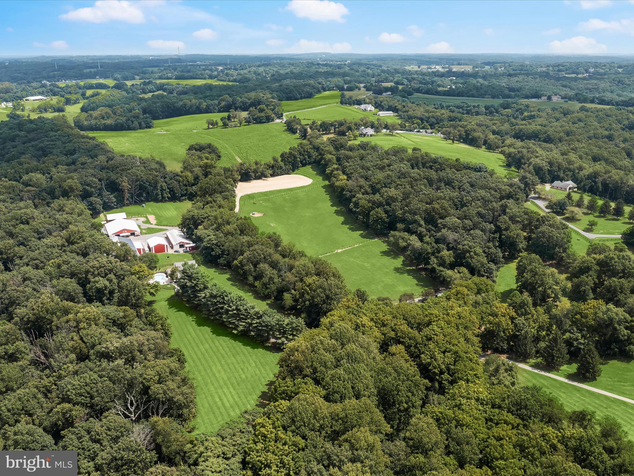 10901 Moxley Road Damascus, MD 20872 - Photo 128 of 148 an aerial view of green landscape with trees houses and lake view