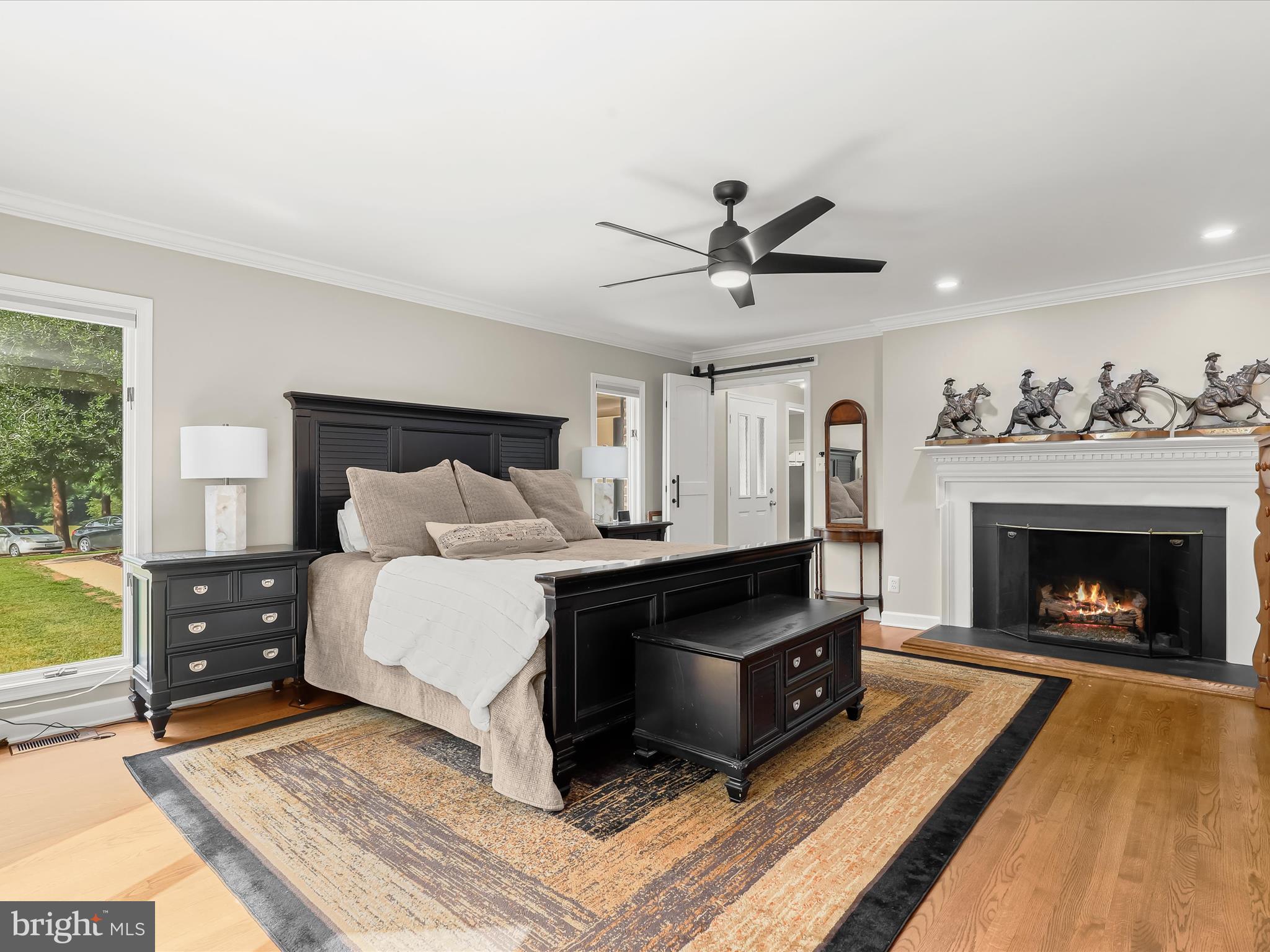 10901 Moxley Road Damascus, MD 20872 - Photo 30 of 148 a spacious bedroom with a bed and a fireplace