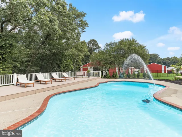 an aerial view of green landscape with trees houses and lake view