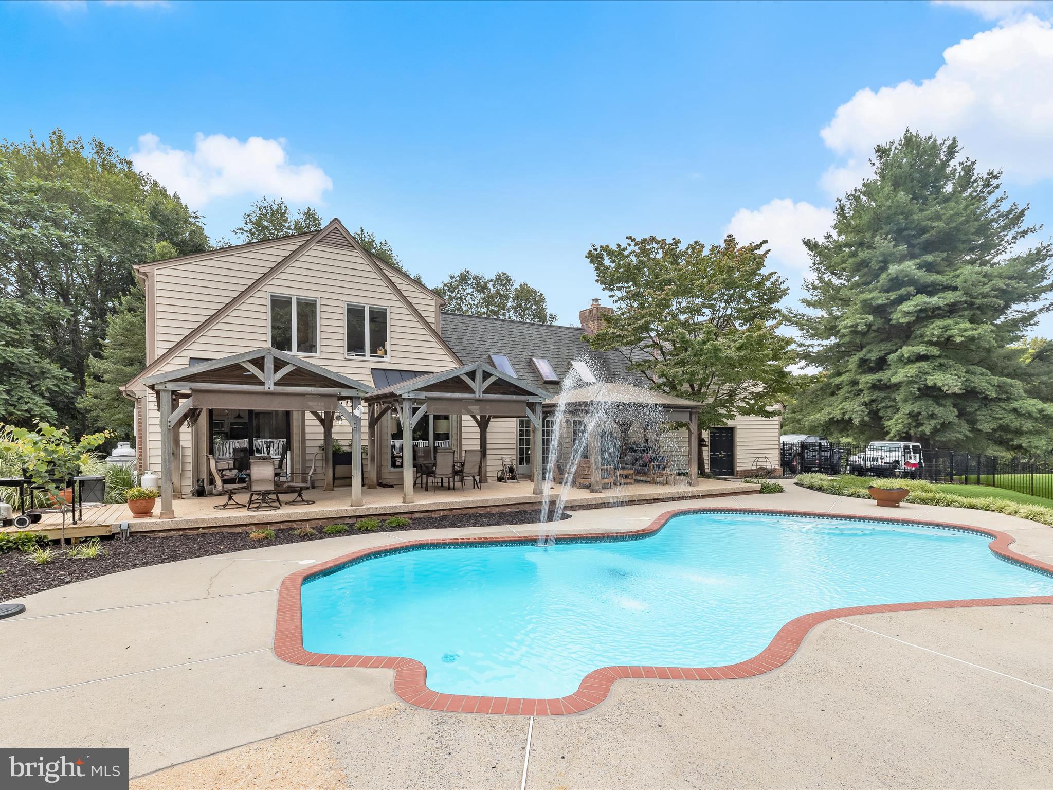10901 Moxley Road Damascus, MD 20872 - Photo 60 of 148 a front view of a house with swimming pool and porch