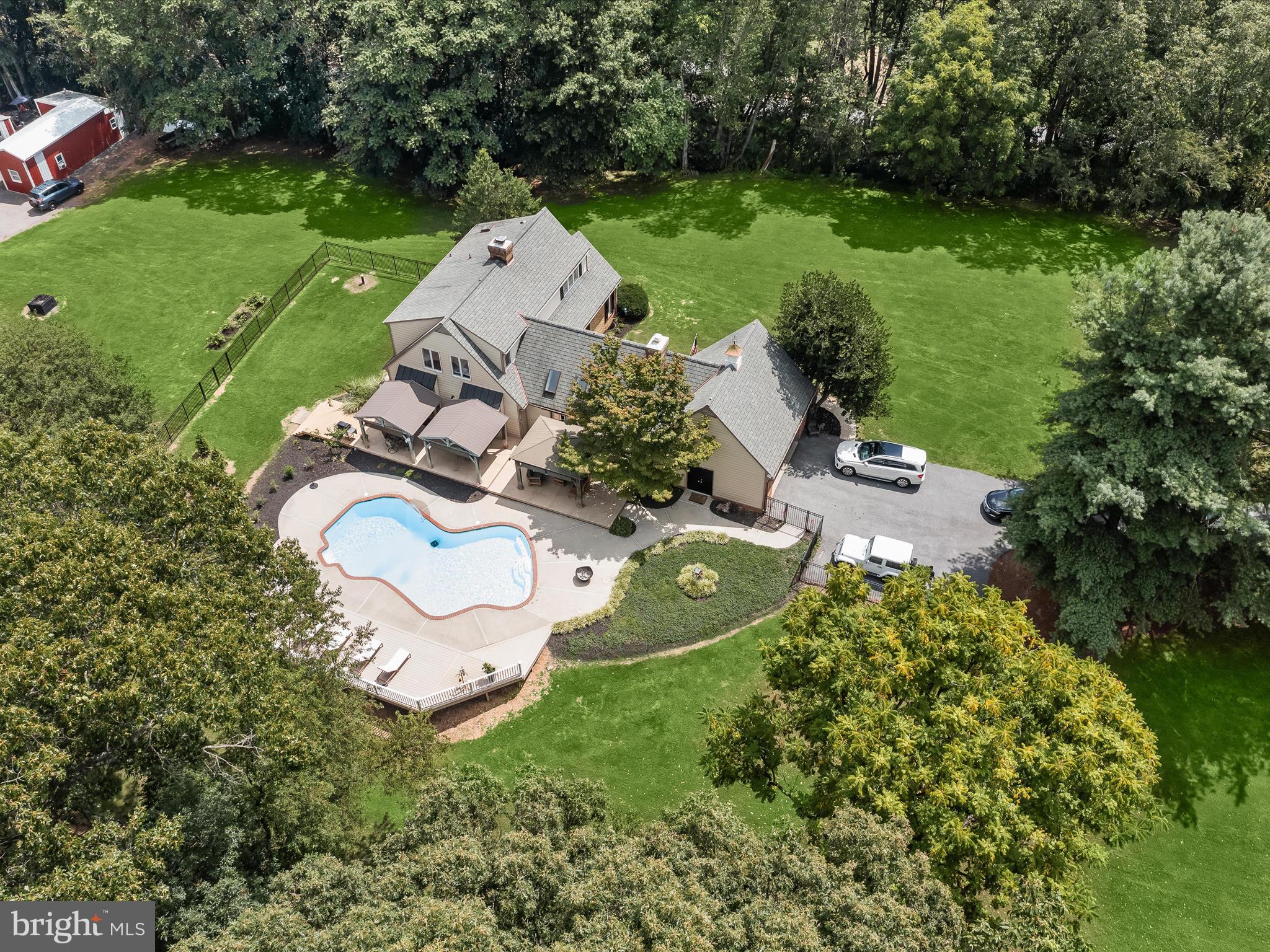 10901 Moxley Road Damascus, MD 20872 - Photo 62 of 148 an aerial view of a house with a garden and swimming pool