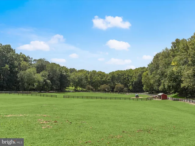 a kitchen with granite countertop a sink a window and stainless steel appliances