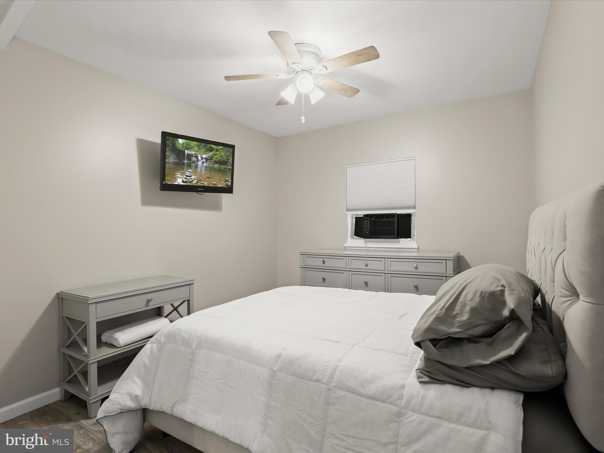 10901 Moxley Road Damascus, MD 20872 - Photo 97 of 148 a bedroom with a bed and a chandelier