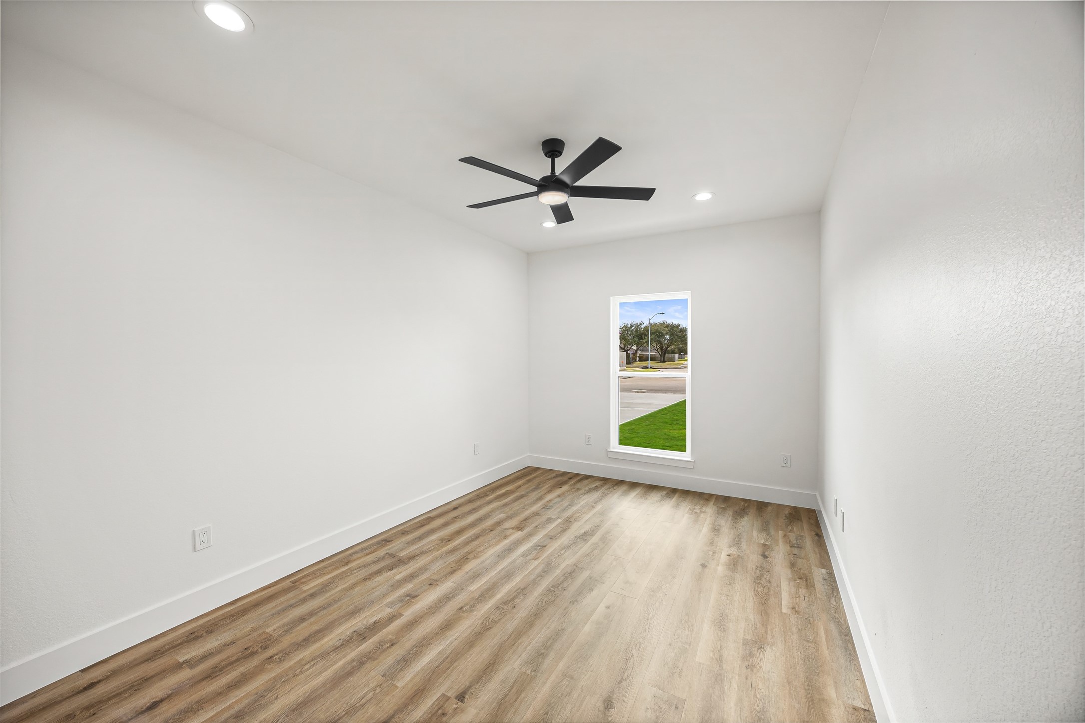 1807 Waco Street Dayton, TX 77535 - Photo 20 of 26 Front bright guest bedroom with ceiling fan, natural light, and modern finishes.