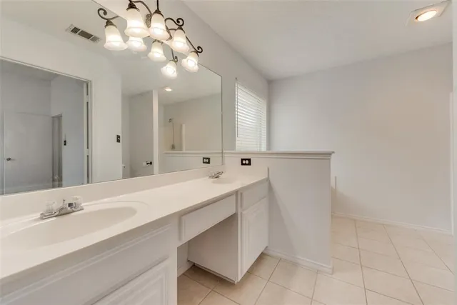 a bathroom with a double vanity sink and a mirror