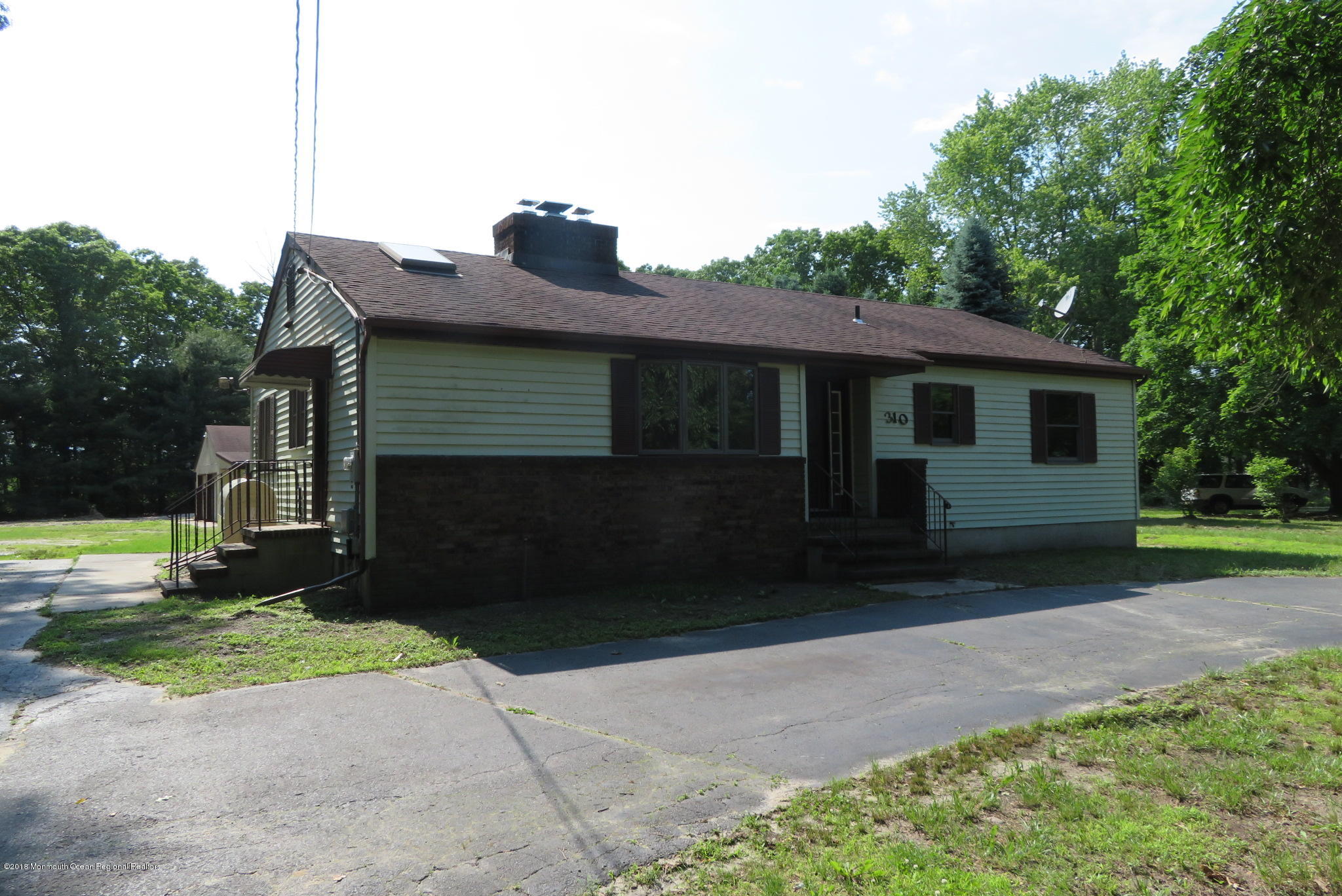310 Colts Neck Road Farmingdale, NJ 07727 - Photo 2 of 15 a front view of a house with garden