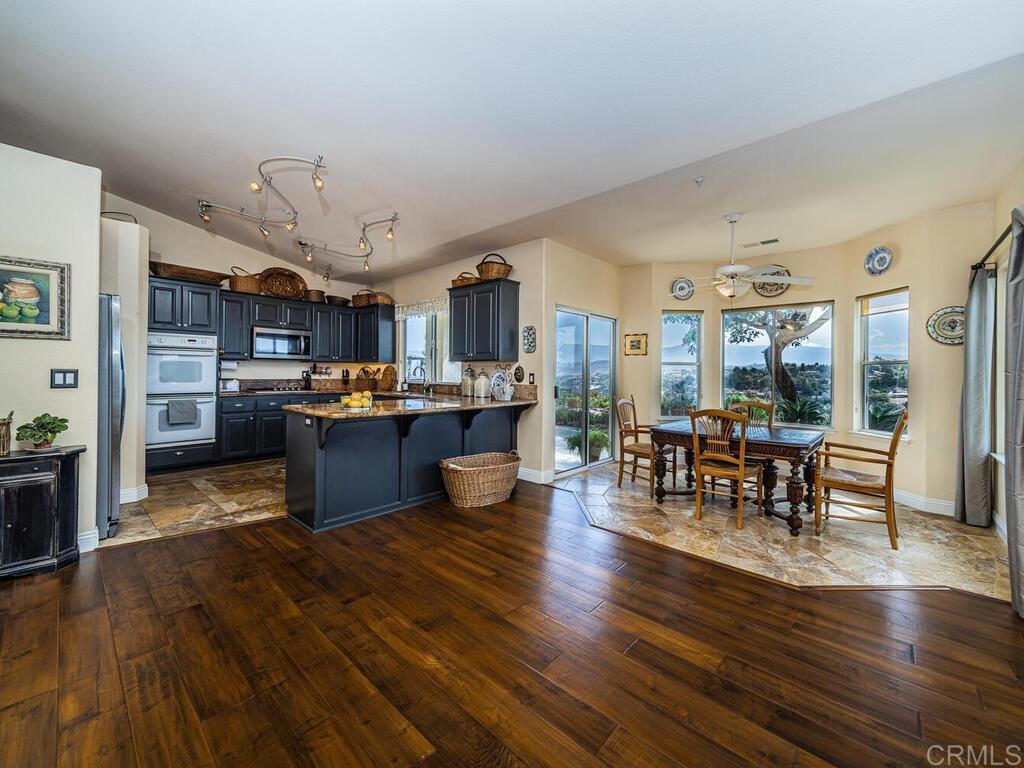 30568 Roadrunner Ridge Valley Center, CA 92082 - Photo 14 of 56 a living room with stainless steel appliances kitchen island granite countertop furniture and a kitchen view