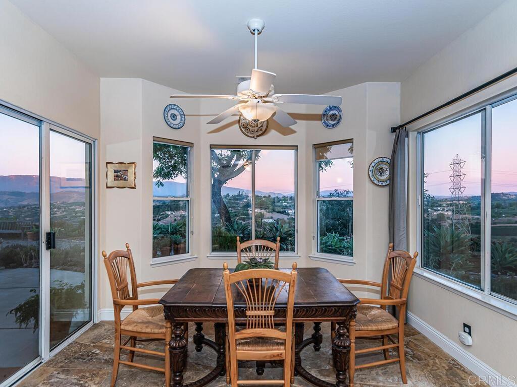 30568 Roadrunner Ridge Valley Center, CA 92082 - Photo 19 of 56 a view of a dining room with furniture large windows and wooden floor