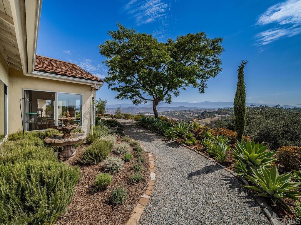 30568 Roadrunner Ridge Valley Center, CA 92082 - Photo 36 of 56 a view of a house with a flower garden