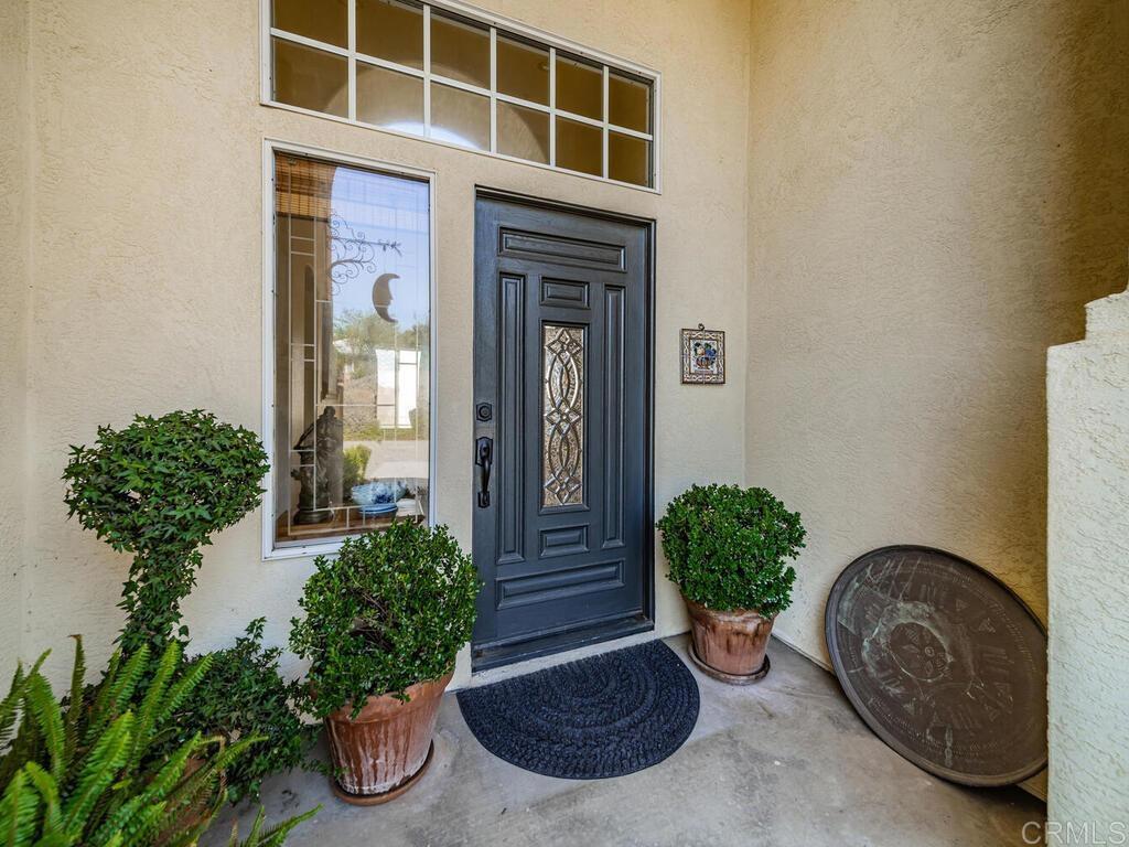 30568 Roadrunner Ridge Valley Center, CA 92082 - Photo 5 of 56 a front view of a house with garden