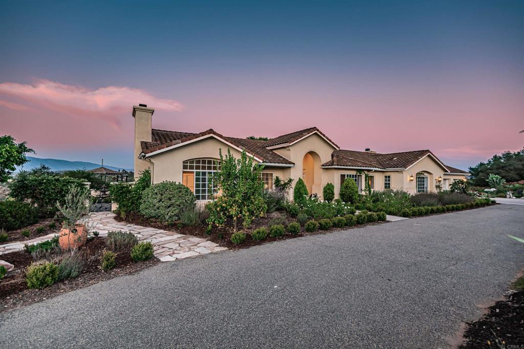 30568 Roadrunner Ridge Valley Center, CA 92082 - Photo 56 of 56 a front view of a house with a yard and street