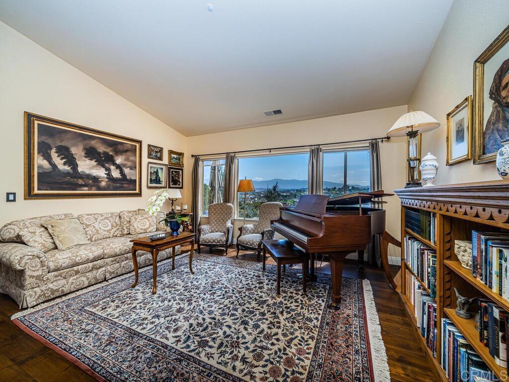 30568 Roadrunner Ridge Valley Center, CA 92082 - Photo 10 of 56 a living room with furniture a bookshelf and a bookshelf