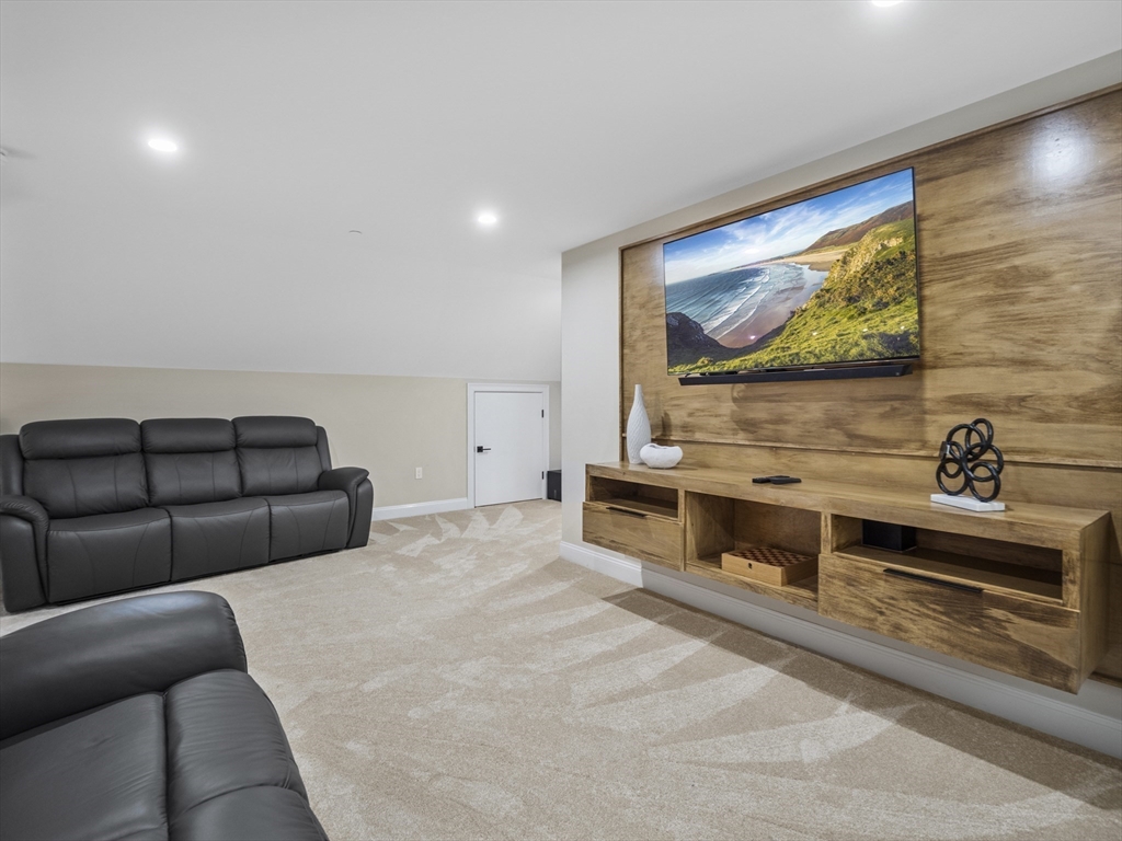 140 Middlesex Street, Unit 3 Lowell, MA 01852 - Photo 21 of 30 a living room with furniture and a flat screen tv