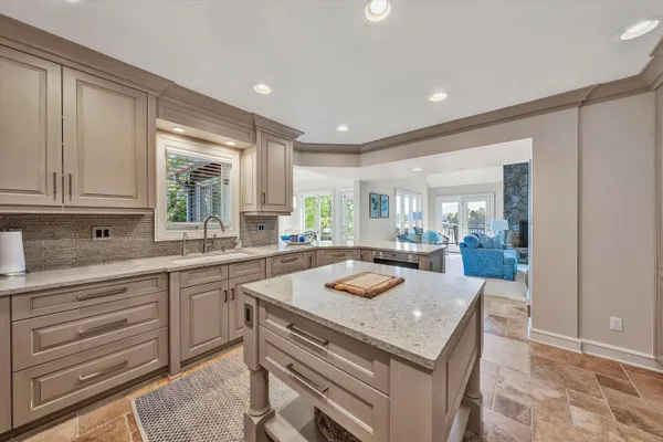 a bedroom with a large bed and a view of kitchen