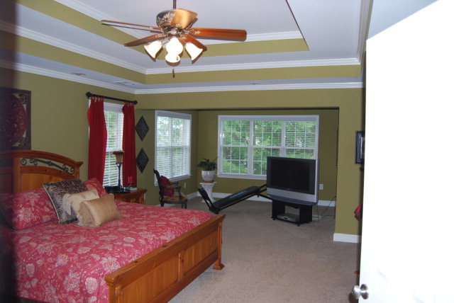 330 Eagle Ridge Road Macon, GA 31216 - Photo 20 of 41 a bedroom with a bed and large windows