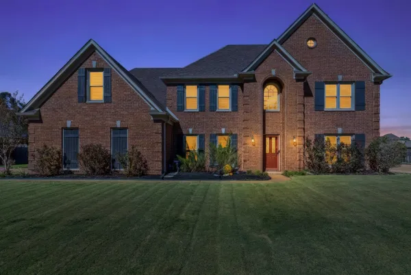 a front view of a house with a yard