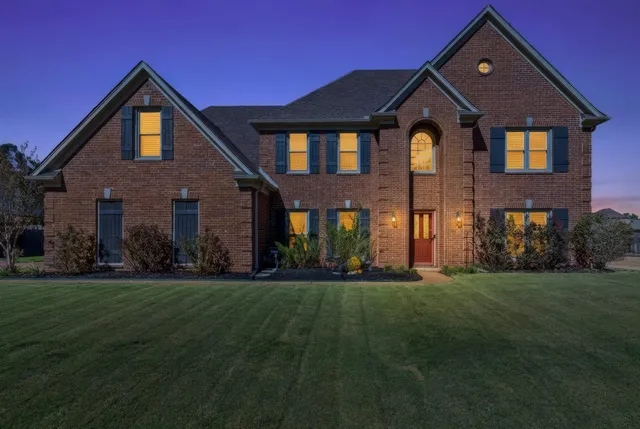 a front view of a house with a yard