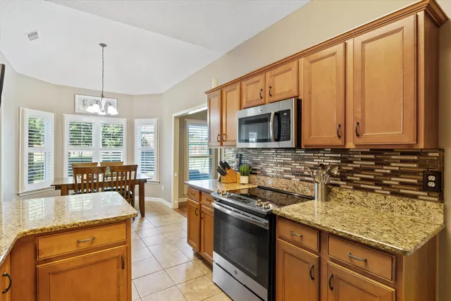 a kitchen with a stove a sink and a microwave