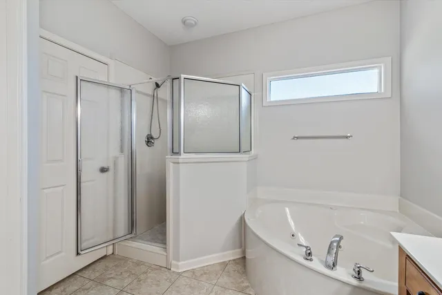 a bathroom with a bathtub and a shower