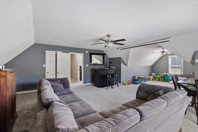 a living room with furniture and a chandelier