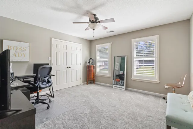 a view of a livingroom with workspace and a window