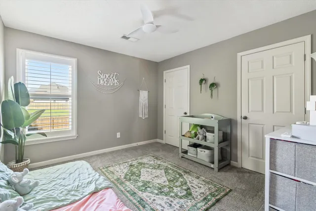 a bedroom with furniture and a window