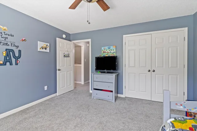 a view of a livingroom with an empty space & a flat screen tv