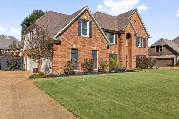 a front view of a house with a yard