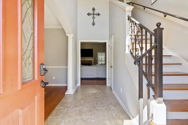 a view of a hallway with wooden floor and staircase