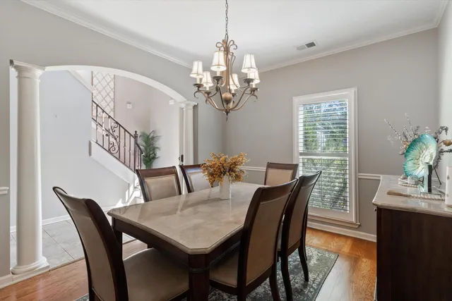 a view of a dining room with furniture window and wooden floor