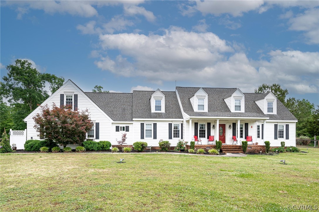 a front view of a house with garden and porch