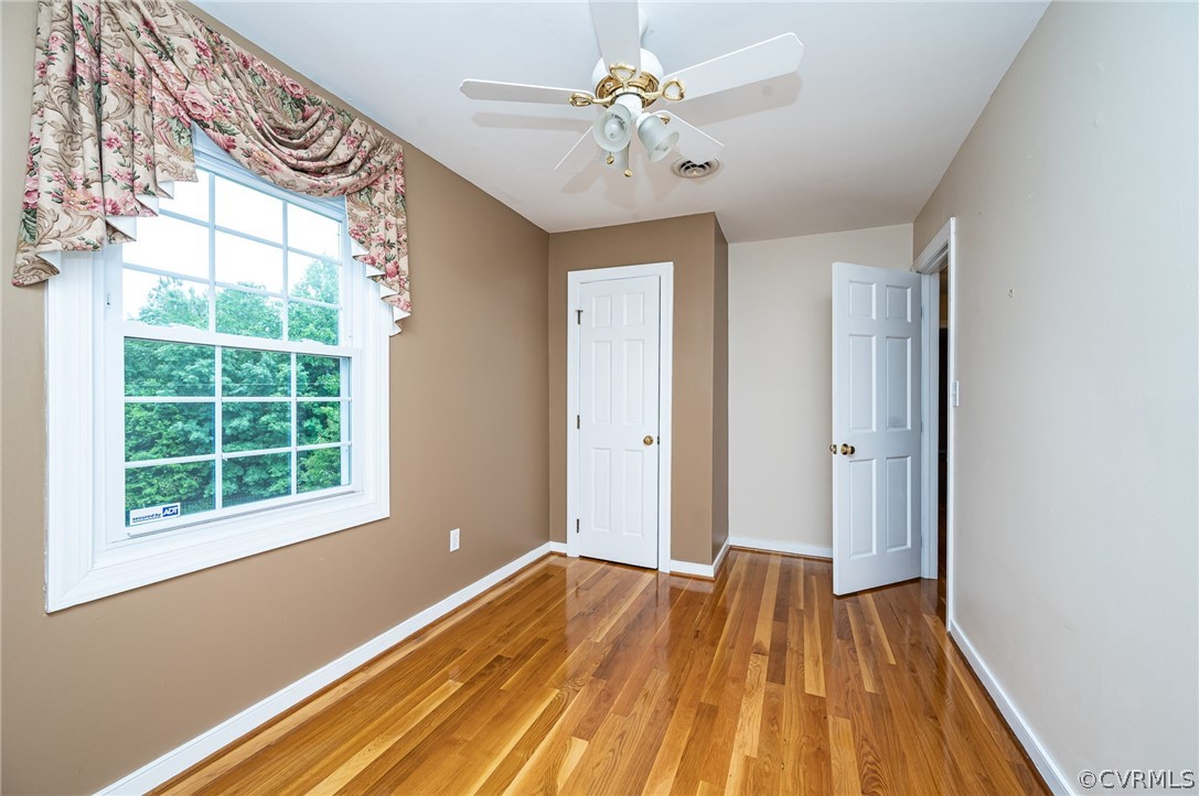 22508 Carson Road Dinwiddie, VA 23841 - Photo 23 of 50 a view of an empty room with wooden floor and a window