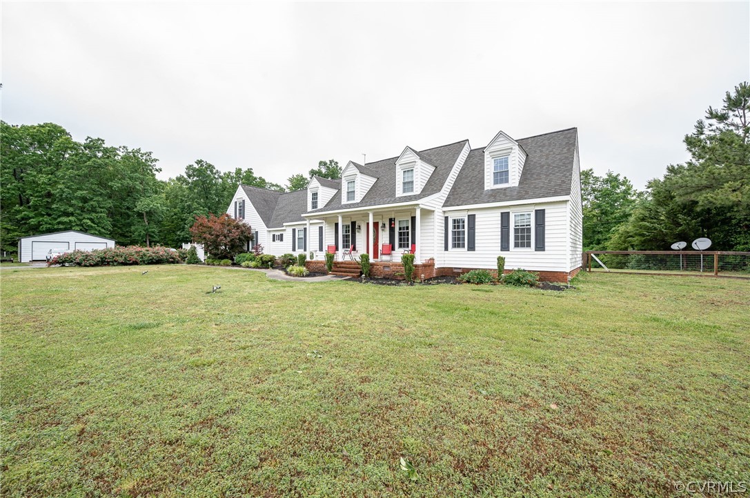 22508 Carson Road Dinwiddie, VA 23841 - Photo 28 of 50 a front view of a house with a garden and trees