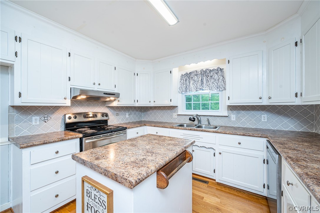 22508 Carson Road Dinwiddie, VA 23841 - Photo 6 of 50 a kitchen with granite countertop kitchen island white cabinets appliances and a window