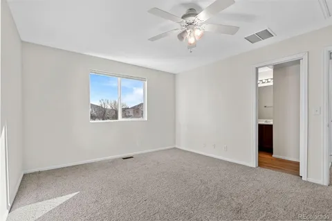 a view of a big room with chandelier fan