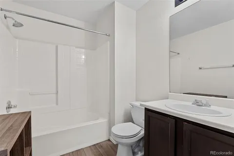 a bathroom with a sink toilet vanity and shower