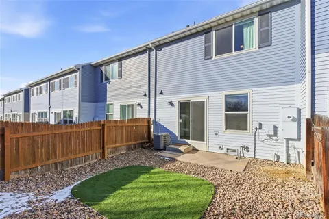 a view of house with backyard and furniture