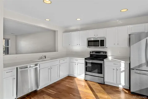 a kitchen with a sink stainless steel appliances and cabinets