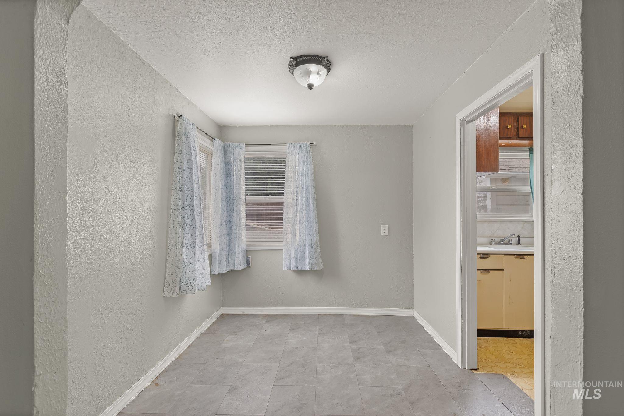 2255 Appleside Boulevard Clarkston, WA 99403 - Photo 12 of 41 Carpeted room with light neutral wall paint, white baseboards, and a semi-flush mount ceiling light fixture