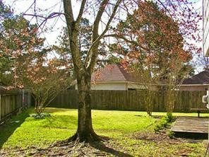 14614 Ridgechase Lane Houston, TX 77014 - Photo 3 of 3 a backyard of a house with lots of green space and fountain