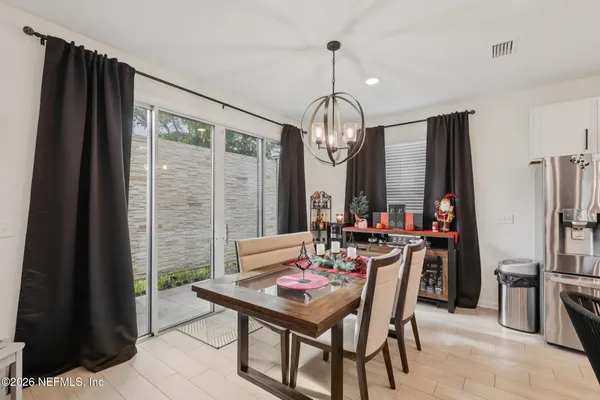 a view of a dining room with furniture and a chandelier