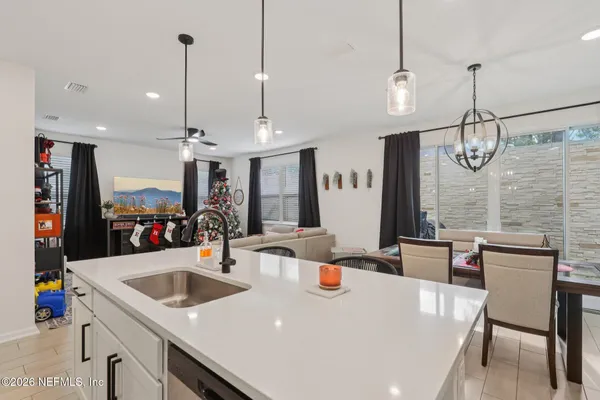 a large kitchen with a table and chairs